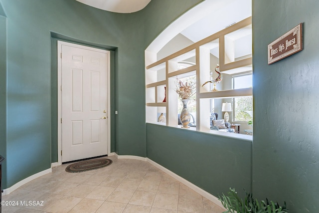 doorway to outside featuring light tile patterned flooring