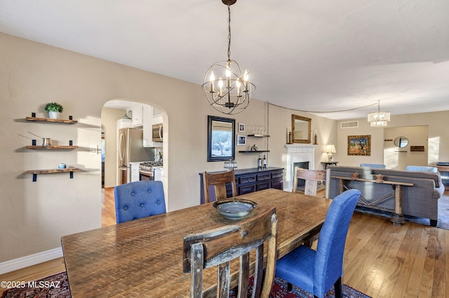 dining room with an inviting chandelier and light hardwood / wood-style flooring