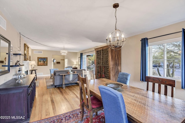 dining room with an inviting chandelier and light wood-type flooring