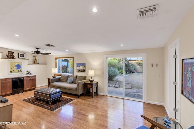 living room featuring ceiling fan and light wood-type flooring