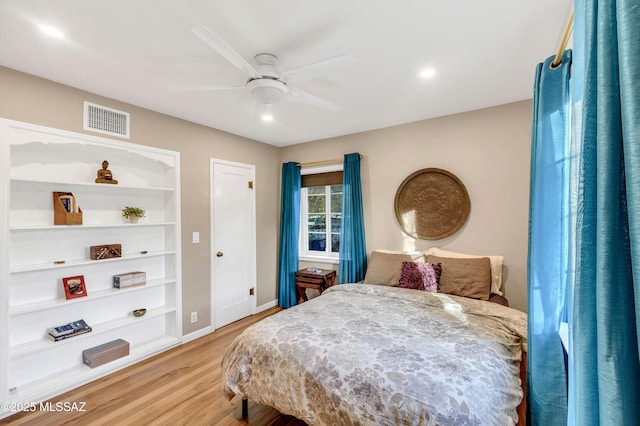 bedroom with light hardwood / wood-style flooring and ceiling fan