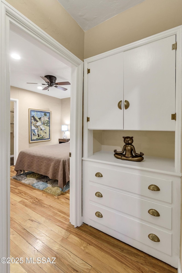 bedroom with light hardwood / wood-style floors and ceiling fan