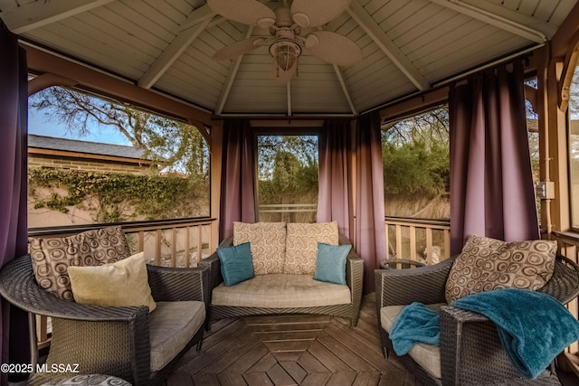 sunroom featuring ceiling fan