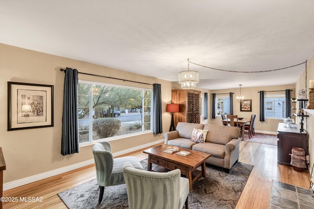 living room with a notable chandelier and hardwood / wood-style flooring