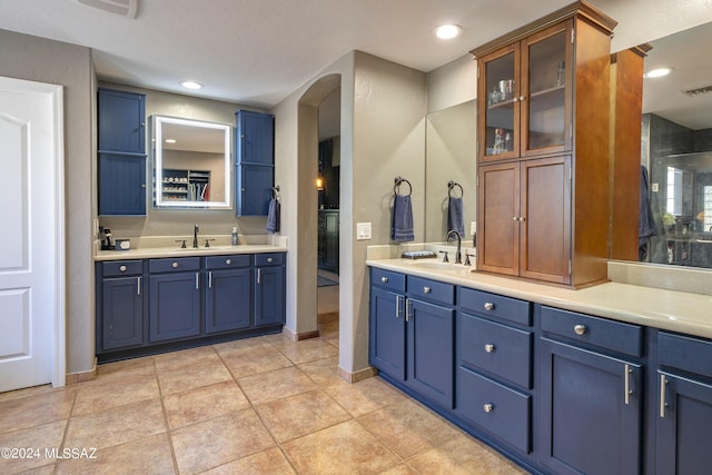 bathroom with tile patterned floors and vanity