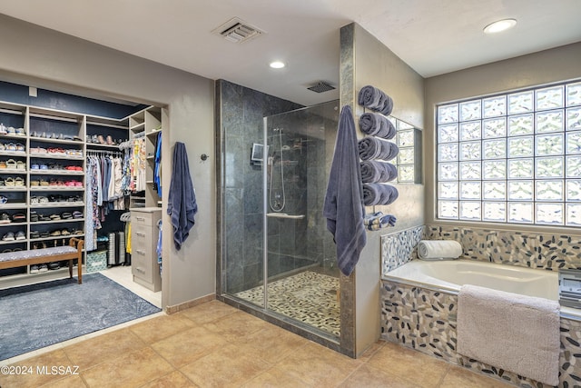 bathroom featuring tile patterned floors and independent shower and bath