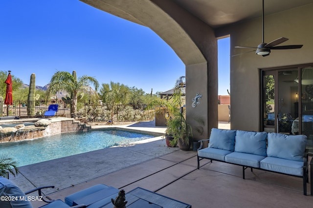 view of swimming pool featuring outdoor lounge area, a jacuzzi, pool water feature, ceiling fan, and a patio