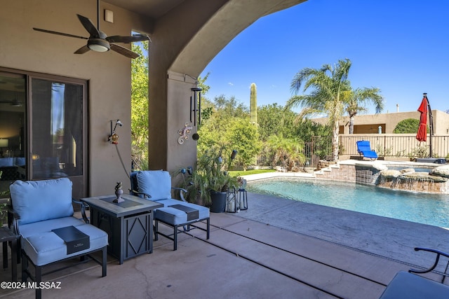 view of pool with an in ground hot tub, a patio, pool water feature, and ceiling fan