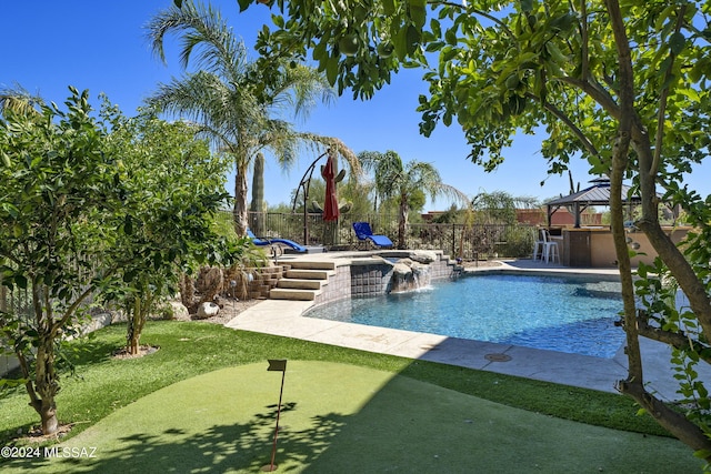 view of swimming pool with pool water feature and exterior bar