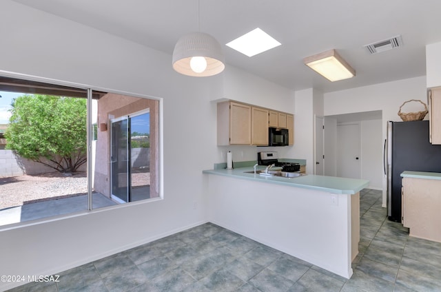 kitchen featuring kitchen peninsula, light brown cabinetry, a skylight, black appliances, and pendant lighting