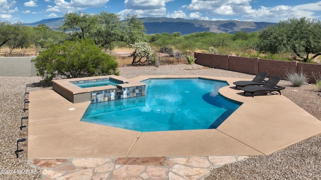 view of pool featuring a fenced in pool, a mountain view, an in ground hot tub, and a patio area