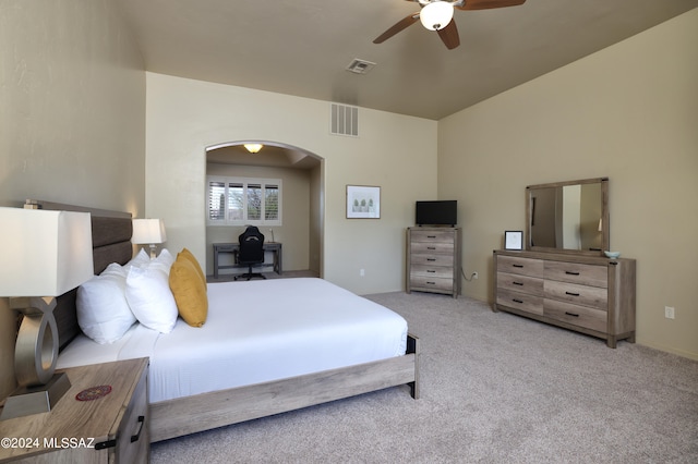 carpeted bedroom featuring arched walkways, a ceiling fan, and visible vents