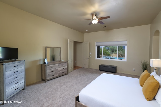bedroom with visible vents, ceiling fan, and light colored carpet