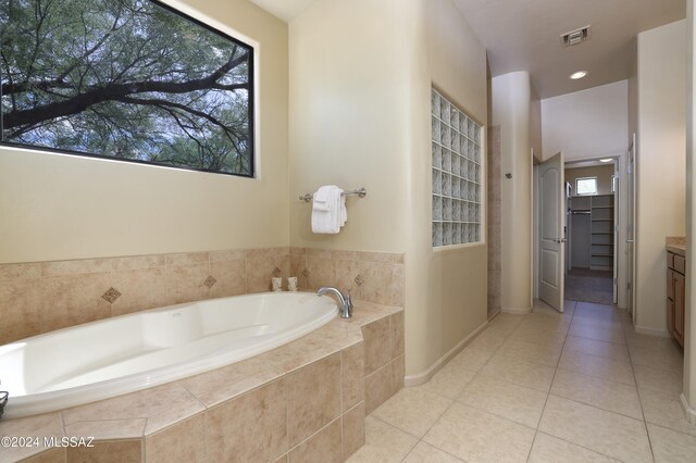 full bathroom with tile patterned floors, visible vents, a healthy amount of sunlight, and a garden tub