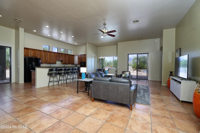 living room featuring plenty of natural light, light tile patterned floors, and visible vents