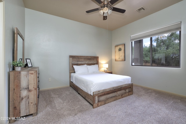 bedroom featuring visible vents, carpet flooring, baseboards, and a ceiling fan