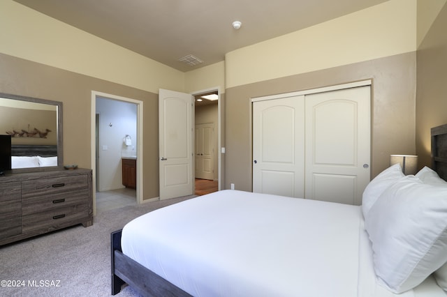 bedroom featuring a closet, carpet flooring, and visible vents