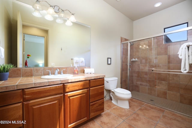 full bath with vanity, tile patterned flooring, a stall shower, and toilet