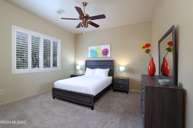 bedroom featuring baseboards, a ceiling fan, carpet flooring, and visible vents