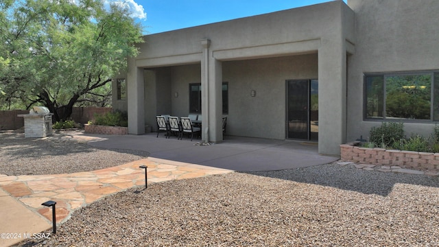 back of house featuring a patio and stucco siding