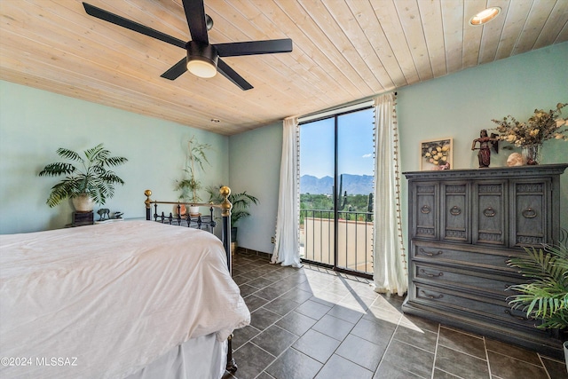 bedroom featuring floor to ceiling windows, ceiling fan, wooden ceiling, a mountain view, and access to outside