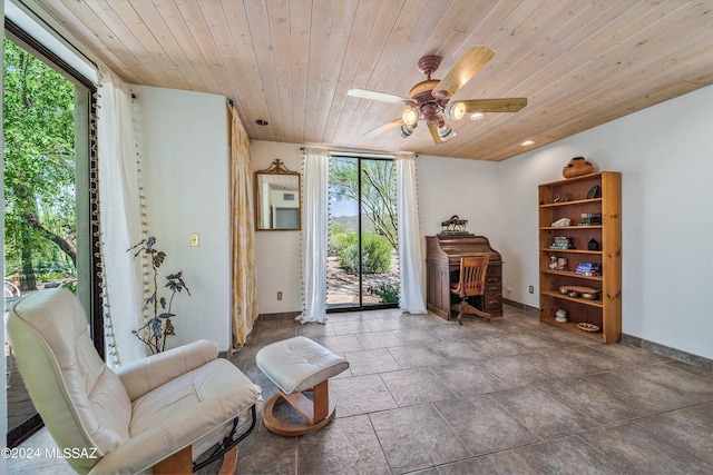 sitting room featuring ceiling fan, a healthy amount of sunlight, and wooden ceiling