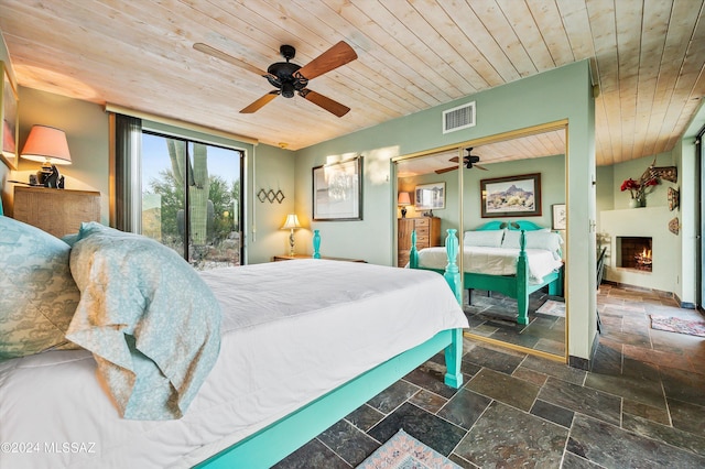 bedroom with access to outside, ceiling fan, and wood ceiling