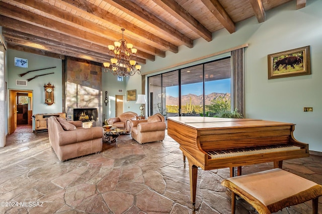 miscellaneous room with a mountain view, beam ceiling, a notable chandelier, a large fireplace, and wood ceiling