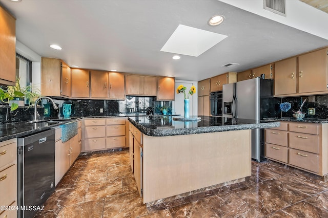 kitchen with a skylight, a center island, sink, decorative backsplash, and black appliances