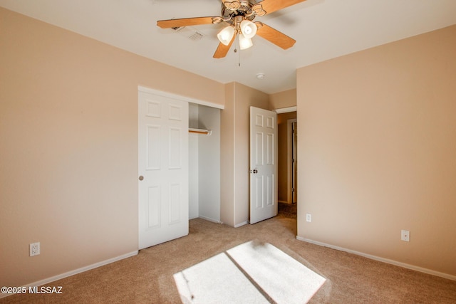 unfurnished bedroom with ceiling fan, light colored carpet, and a closet