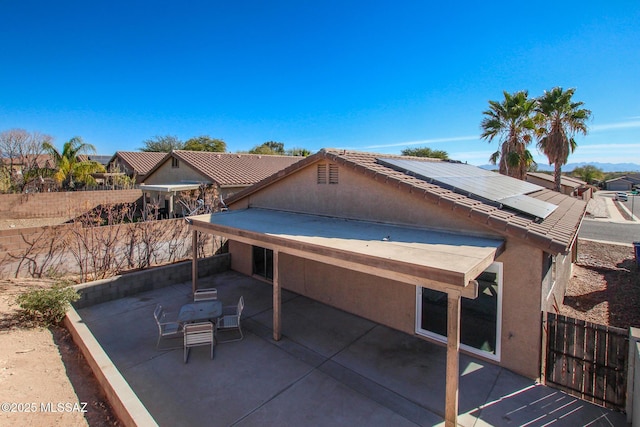 exterior space featuring a patio area and solar panels