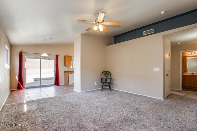 unfurnished living room with vaulted ceiling, ceiling fan, and light carpet