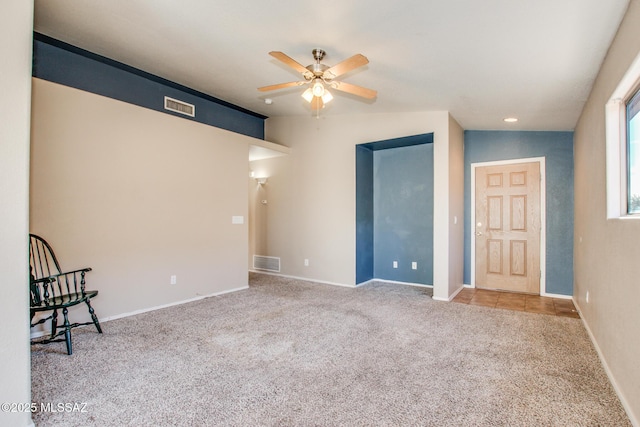 carpeted empty room featuring ceiling fan and lofted ceiling