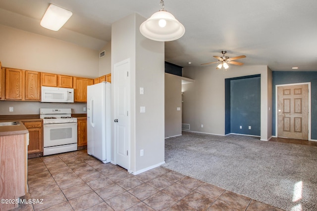 kitchen featuring white appliances, decorative light fixtures, light colored carpet, ceiling fan, and lofted ceiling