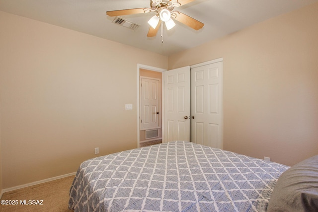 carpeted bedroom featuring a closet and ceiling fan