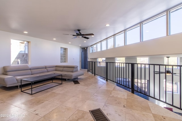 living room with ceiling fan and plenty of natural light