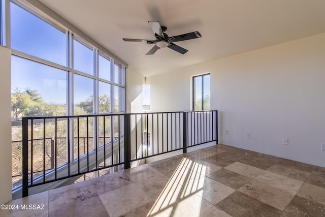 unfurnished room with ceiling fan