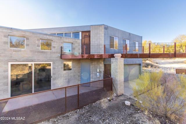 rear view of house featuring a balcony