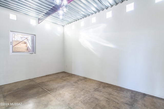 unfurnished room with concrete flooring