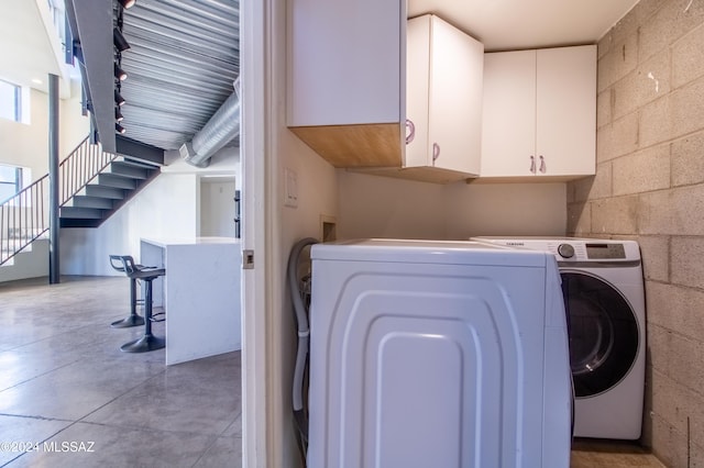 washroom with cabinets and separate washer and dryer