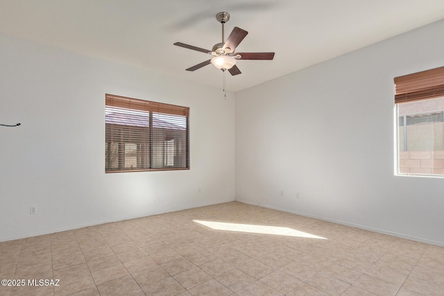 spare room featuring light tile patterned flooring and ceiling fan