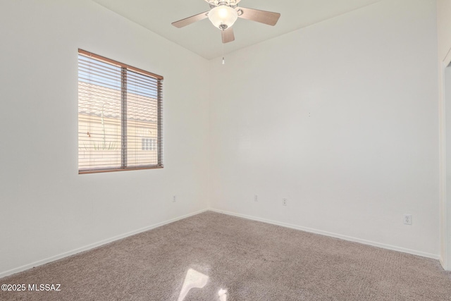 carpeted spare room with ceiling fan