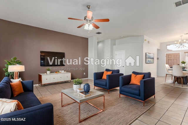 tiled living room with ceiling fan with notable chandelier