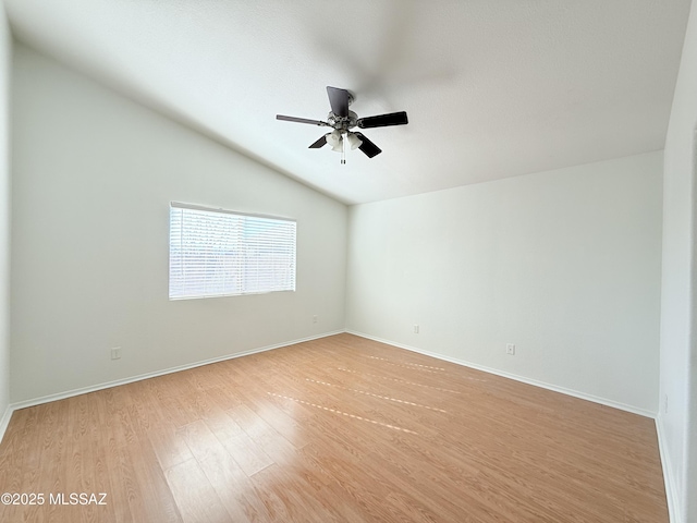 spare room featuring ceiling fan, vaulted ceiling, and light hardwood / wood-style flooring