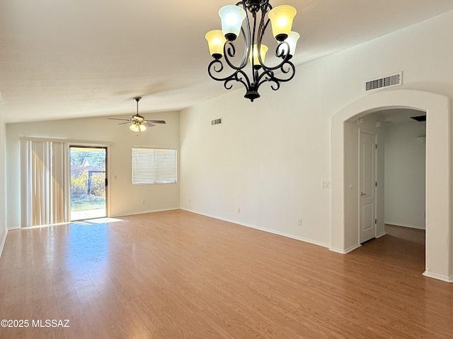 spare room featuring ceiling fan with notable chandelier and wood-type flooring