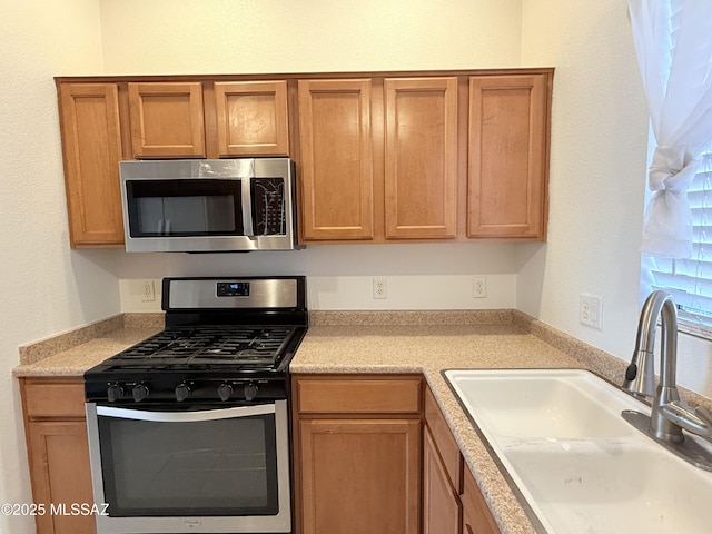 kitchen with sink and appliances with stainless steel finishes