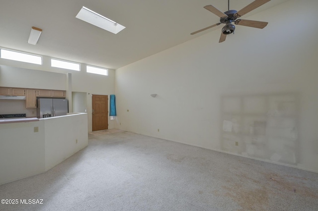 carpeted spare room featuring high vaulted ceiling and ceiling fan