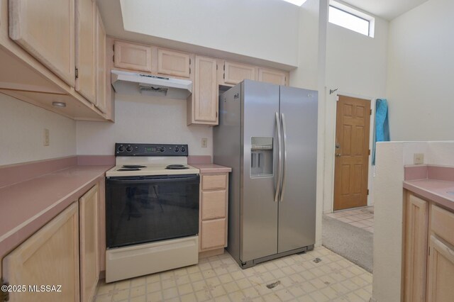 kitchen featuring light brown cabinets, stainless steel fridge with ice dispenser, white electric stove, and a high ceiling