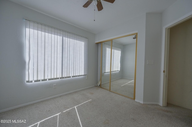 unfurnished bedroom with ceiling fan, a closet, and light colored carpet