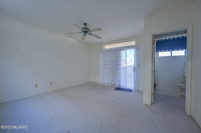 empty room with ceiling fan and light colored carpet